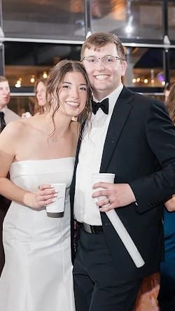 A newly married couple on the dance floor surrounded by guests
