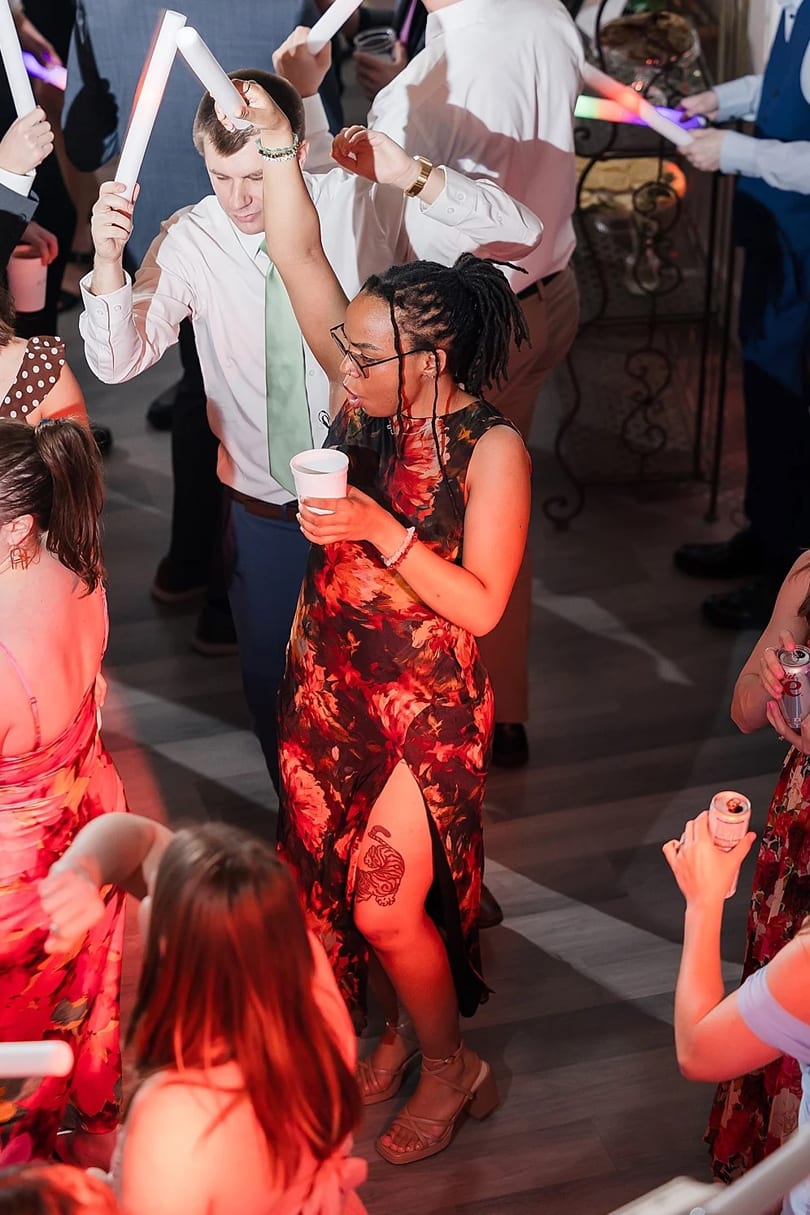 Guests dancing with glowing foam sticks