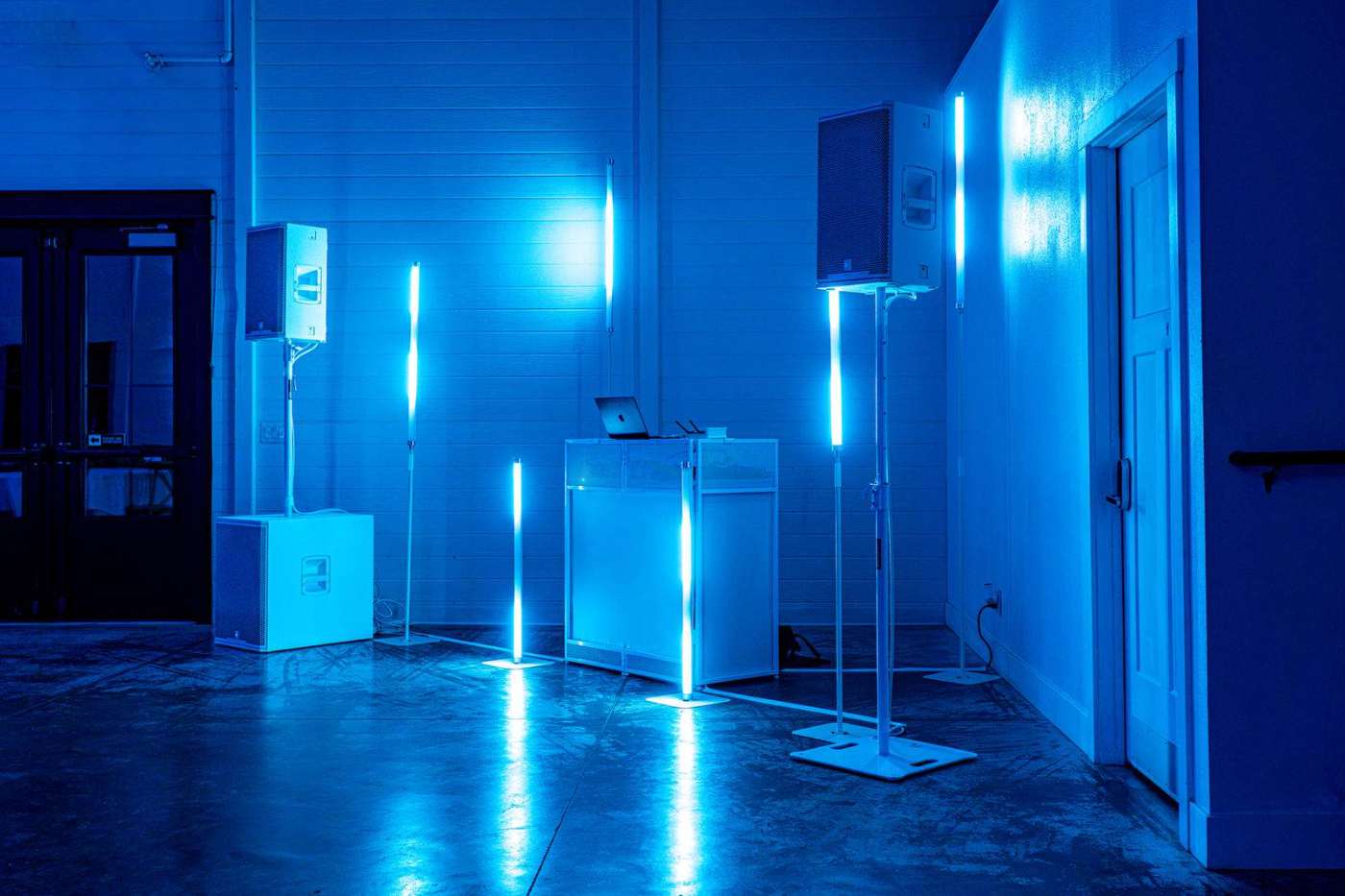 Davin’s white booth and blue tube lighting set in a wedding venue